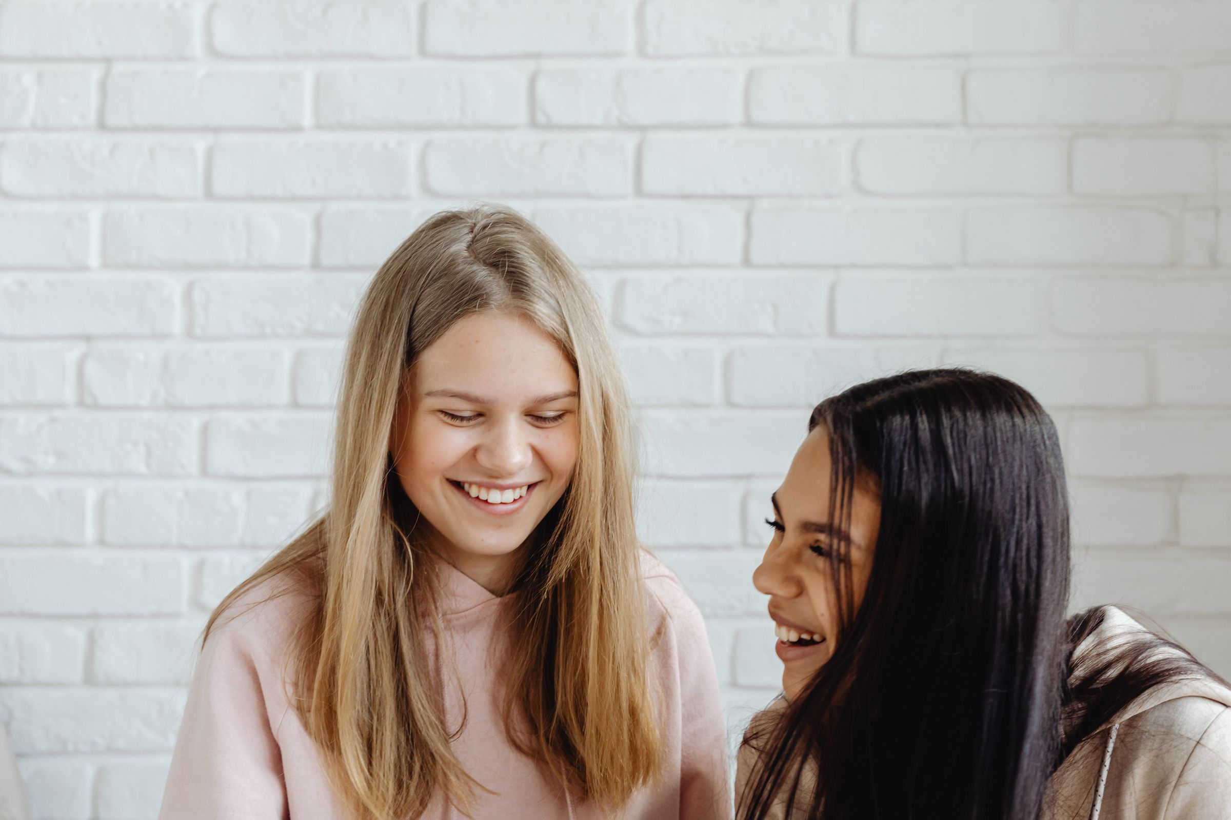 Two teenagers laughing together